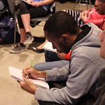 Student taking notes at the Fakes News discussion panel