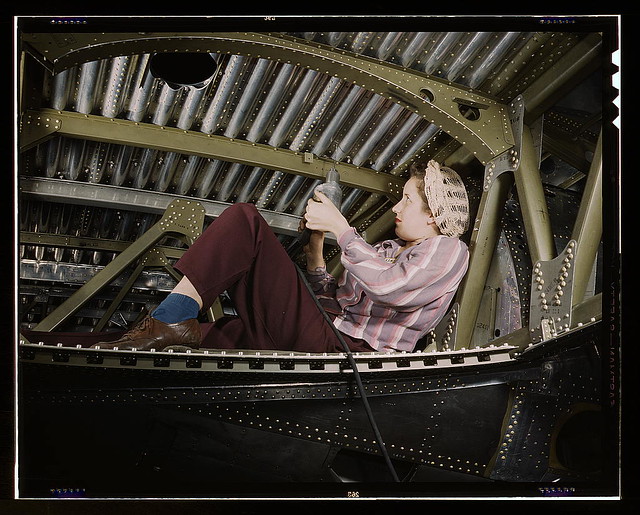 An A-20 bomber being riveted by a woman worker at the Douglas Aircraft Company plant at Long Beach, Calif. (LOC)