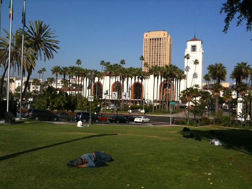 Union Station, with homeless people sleeping on the grass in the foreground