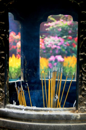 Incense with flowers behind