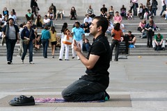 Praying in Trafalgar Square by www.alastairhumphreys.com