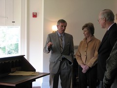 Director Frank Milligan, First lady Laura Bush, and National Trust President Richard Moe stand next to a reproduction of the desk that was in the Cottage when the Lincolns lived there. The original desk is at the White House.
