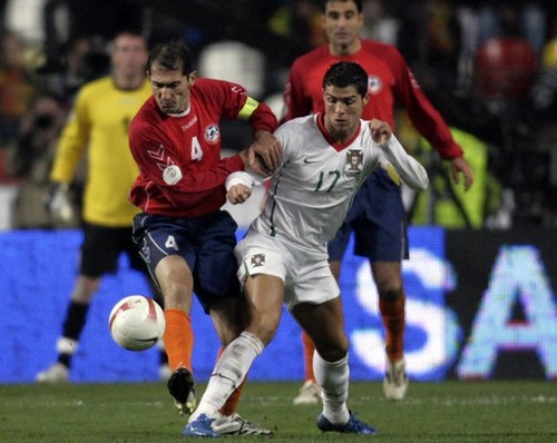 Cristiano Ronaldo is challenged by Armenia's Sargis Hovsepyan during Euro 2008 Group A qualifying