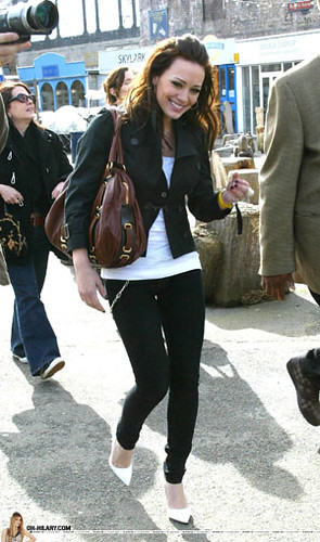 Hilary Duff going around with black jacket, white heels, black skinny jeans