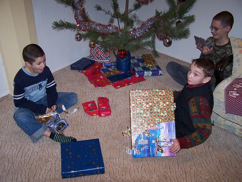 Joshua, Maxime, and Dominic opening presents on New Year's Eve