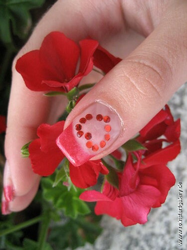 nail art red heart design holding flower