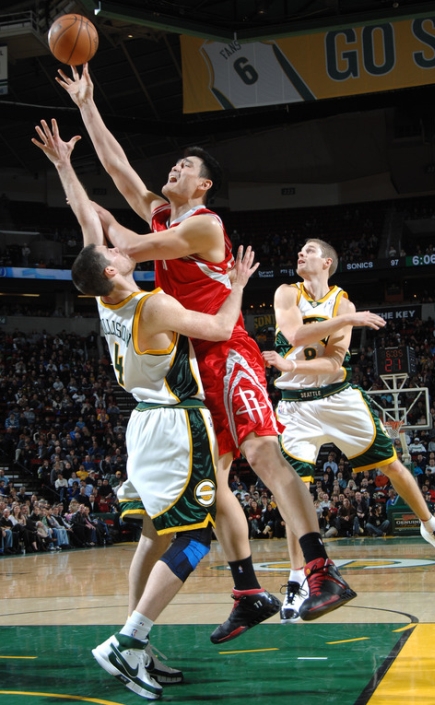 Yao Ming takes it strong to the hole against Seattle's Nick Collison.  Yao scored 26 points on 6-of-13 shooting and 14-of-15 from the free throw line.  He also had 12 rebounds and 6 assists to team up with Tracy McGrady (28 points) to overcome a 13-point deficit in the fourth quarter for a miracle win against a team that had lost 11 in a row before the game.