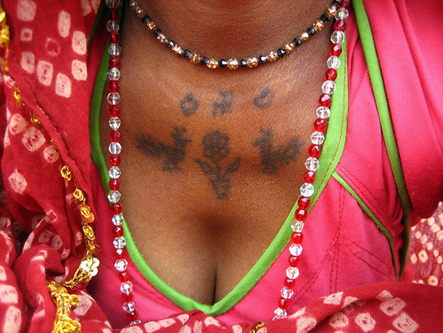 Peacock (morvi) tattoos on a tribal woman in the slum at Gulbai Tekra. 