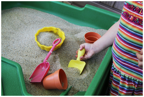 Toddler playing at her sand and water table