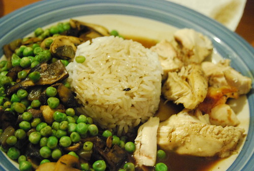 Roast chicken, rice, peas with mushrooms and gravy all over