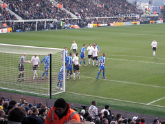 Fulham players in white and Wigan in blue strips
