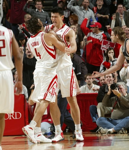 Yao Ming celebrates with teammate Luis Scola after Yao grabbed a huge rebound and threw it down against Tim Duncan late in the Rockets' game against the Spurs.  Yao scored 21 points and grabbed 14 boards in an intense victory to help Houston snap a two-game losing streak.