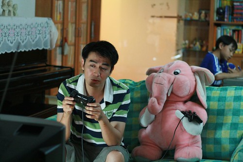 Dad (Chye Chee Keong) playing PS2 with Pinky the Pink Elephant