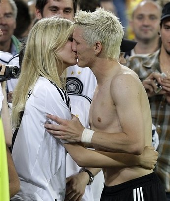 Bastian Schweinsteiger kisses his girlfriend Sarah Brandner after the quarterfinal match