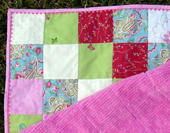 corner of girly patchwork quilt with rick rack