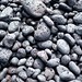 Rocks by the black sand beach by Tom Coates