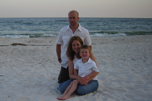 family photo with white shirts on the beach