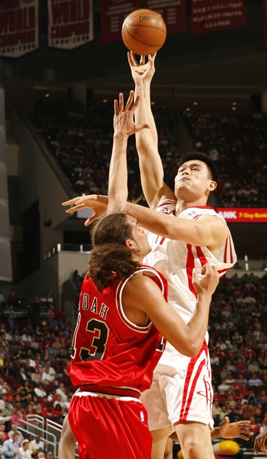 Yao Ming shoots a jump hook over Chicago rookie Joakim Noah on Sunday night to help the Rockets win their 12th game in a row, beating the Bulls 110-97.  Yao's firepower wasn't needed as much since 6 other Rocket players scored in double figures.  Yao would finish with 12 points and 6 boards.