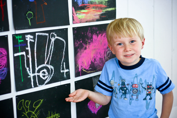Showing off his drawing at the art show
