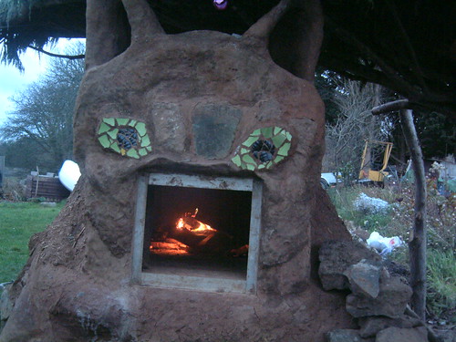 fire in the cat mud oven – cat cob sculpture – stonewill