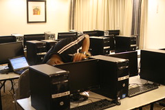 Michuki Mwangi surrounded by rows of desks covered with computers