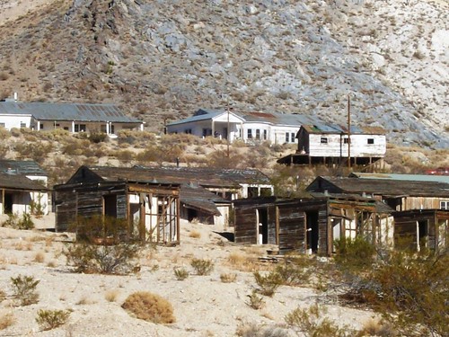 Abandoned mine buildings (Anaconda Copper Mining Company) in the bright sunlight on the outskirts of Darwin, a ghost town outside Death Valley, CA - darwin08x