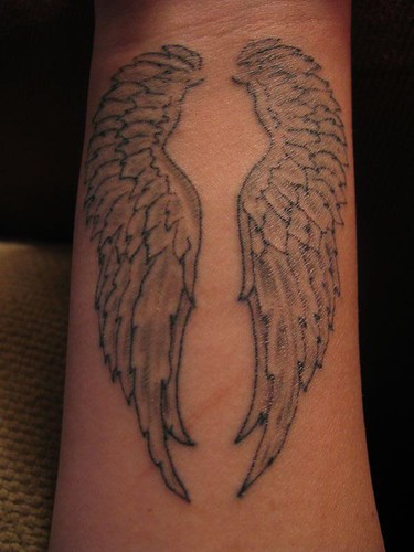 angel wings on a wrist tattoo
