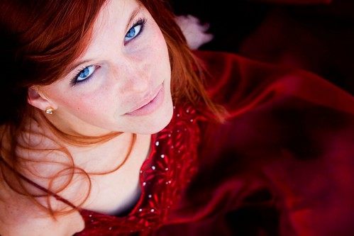 Gorgeous photo of a young lady in a red dress. The red dress and red hair 