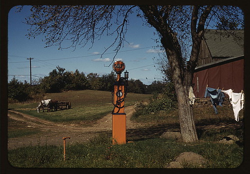 [Gas pump with clothesline, barn and horse-drawn wagon in background] (LOC)