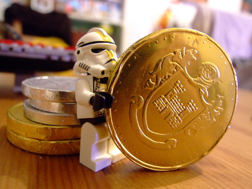 Storm trooper, holding a big gold coin