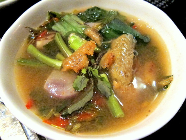 Dtom klong bai makam sai pla grob (Spicy soup infused with smoked fish and young tamarind leaves)