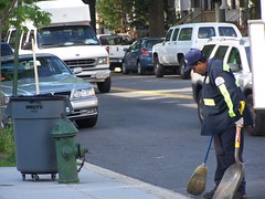 DPW worker cleaning the street and sidewalk