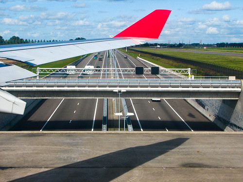 Airplane over road cars Schiphol Amsterdam, Netherlands