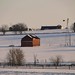 red barn in snow field
