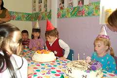 Birthday boy and girl blowing out candles