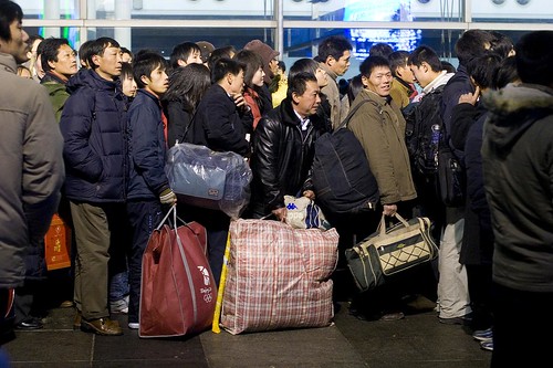 Millions of Chinas migrant workers wait in line to board trains to get home in time for Chinese New Year.