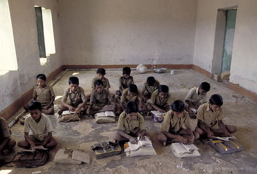 Kids sitting down reading but where is the teacher?