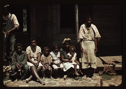 Bayou Bourbeau plantation, a FSA cooperative, Natchitoches, La. A Negro family (?) seated on the porch of a house (LOC)