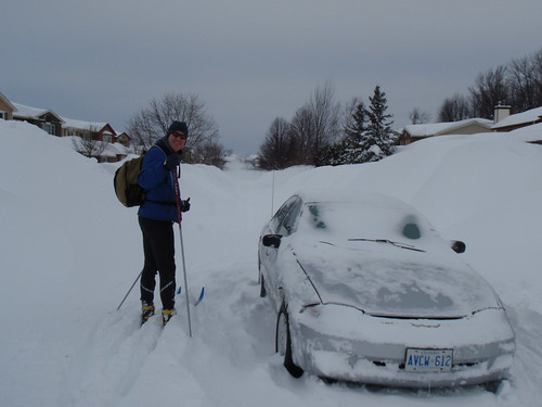 Scott skiing around abandoned car in the middle of the road.