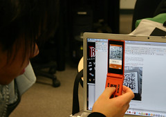 Japanese Visitor Shows QR Code Ready Mobile Ph...