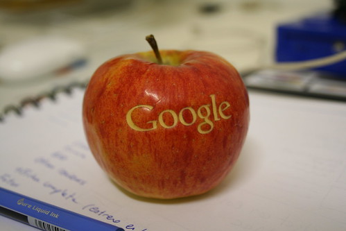 An apple with the logo of Google made with laser