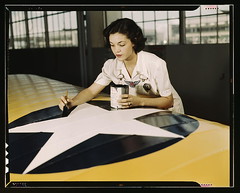 Painting the American insignia on airplane win...