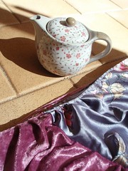 pink and grey scarf and teapot