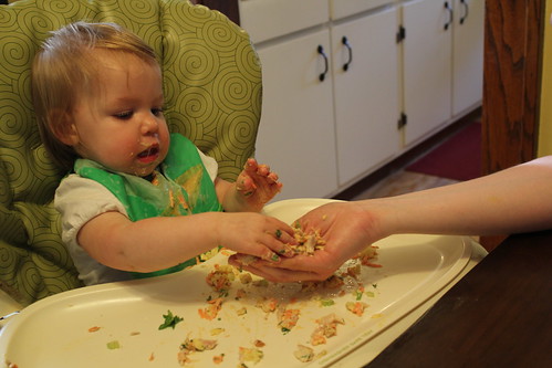 Putting the chicken salad in mom's hand