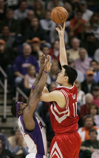 Yao Ming shoots a huge jump hook over the Phoenix Suns' Amare Stoudemire Wednesday night that gave the Rockets a 96-92 lead with 1:08 remaining in the game.  Yao would finish with a monster game, scoring 31 points and grabbing 13 boards in the victory.
