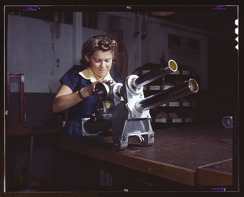 Warbird picture - A young woman employee of North American Aviation, Incorporated, working over the landing gear mechanism of a P-51 fighter plane, Inglewood, Calif. The mechanism resembles a small cannon (LOC)