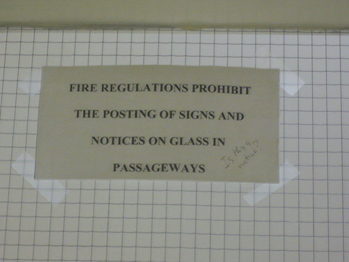 Fire regulations prohibit the posting of signs and notices on glass in passageways.