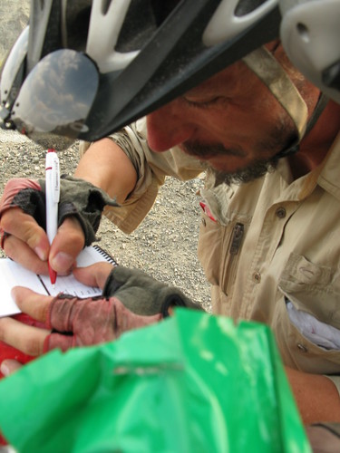 Asmund Pink Gloves signs the GWR logbook at MM4060 on G312 in Xinjiang Province, China