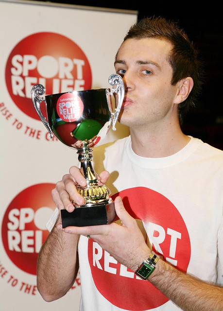 mark selby. Mark Selby kisses his trophy after compleeting his madcap Mile around a snooker table