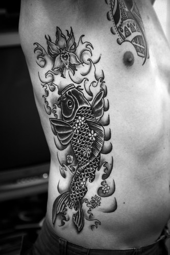 Koi and orchid Tattoo by The Tattoo Studio